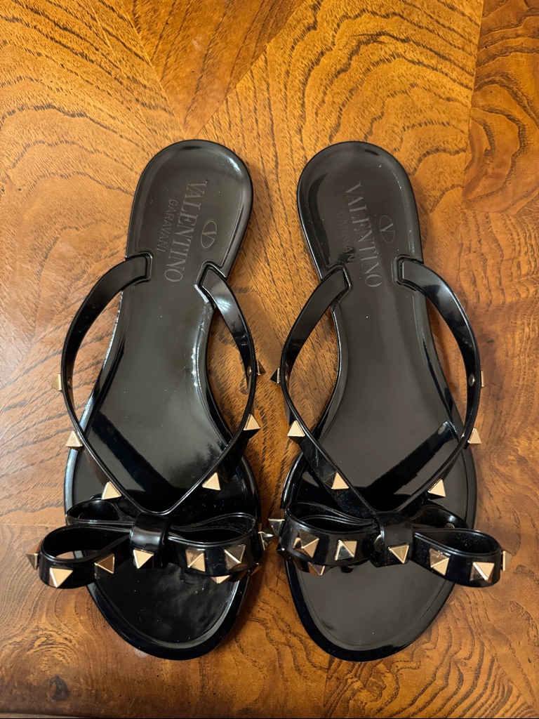 Valentino Black Jelly Sandals With Gold Rockstud Bow